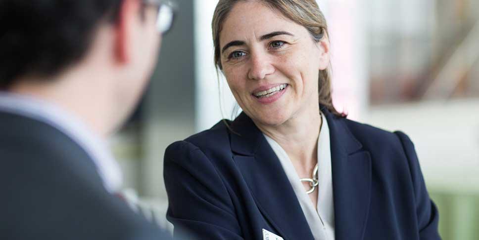 Yvonne Maher, executive vice president for Development and Donor Services, talks with a Foundation donor at the Energy Innovation Center, which is dedicated to developing a socially responsible workforce, advancing energy and sustainable technology, and promoting diversity, innovation and comprehensive education.