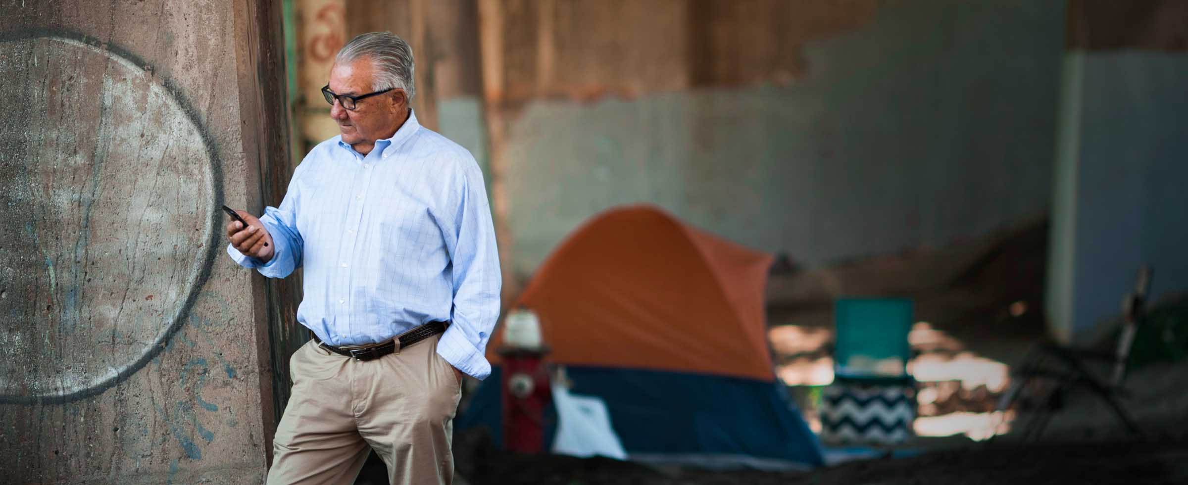 Terry Serafini at a homeless encampment under the 31st Street Bridge.