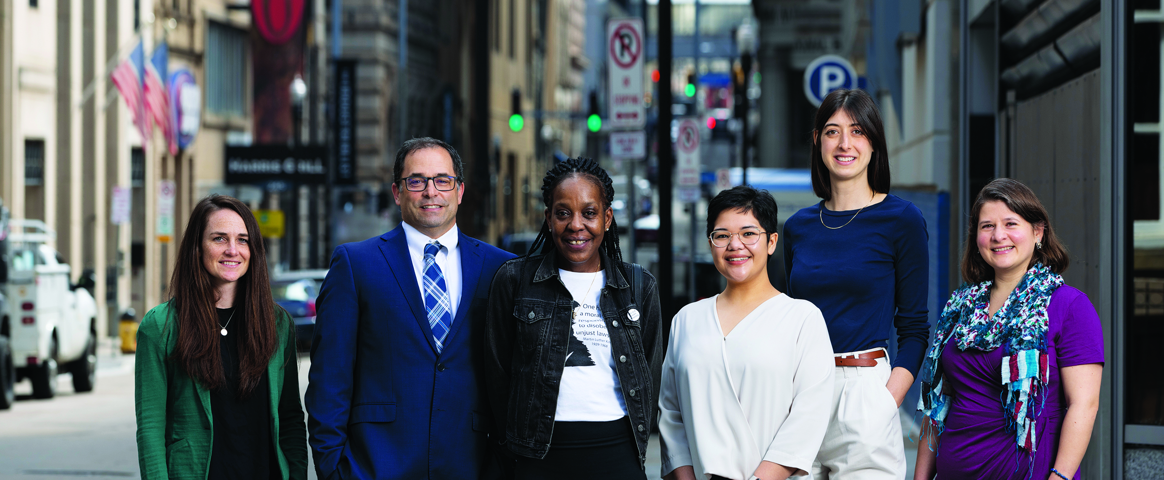 Six members of the Foundation's Public Health, Research and Learning staff are standing on the sidewalk of Fourth Avenue in downtown Pittsburgh.