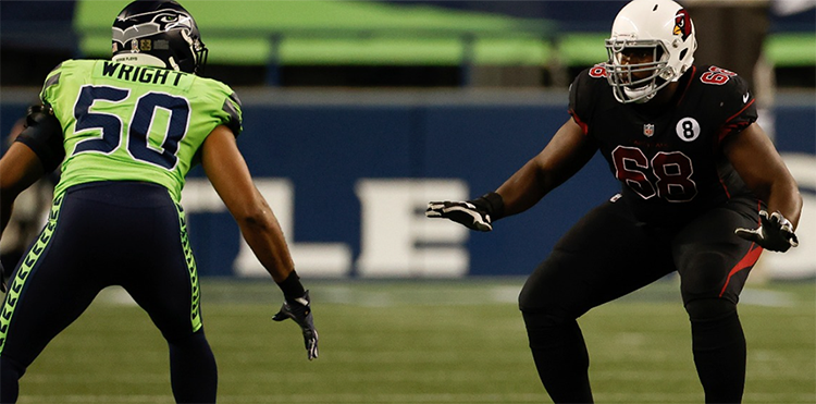 Kelvin Beachum is pictured on the right in his Arizona Cardinals uniform on the football field with a Seattle Seahawks opponent. Photo was provided courtesy of the Arizona Cardinals.
