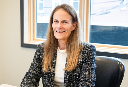 Beth Genter sitting at a desk.