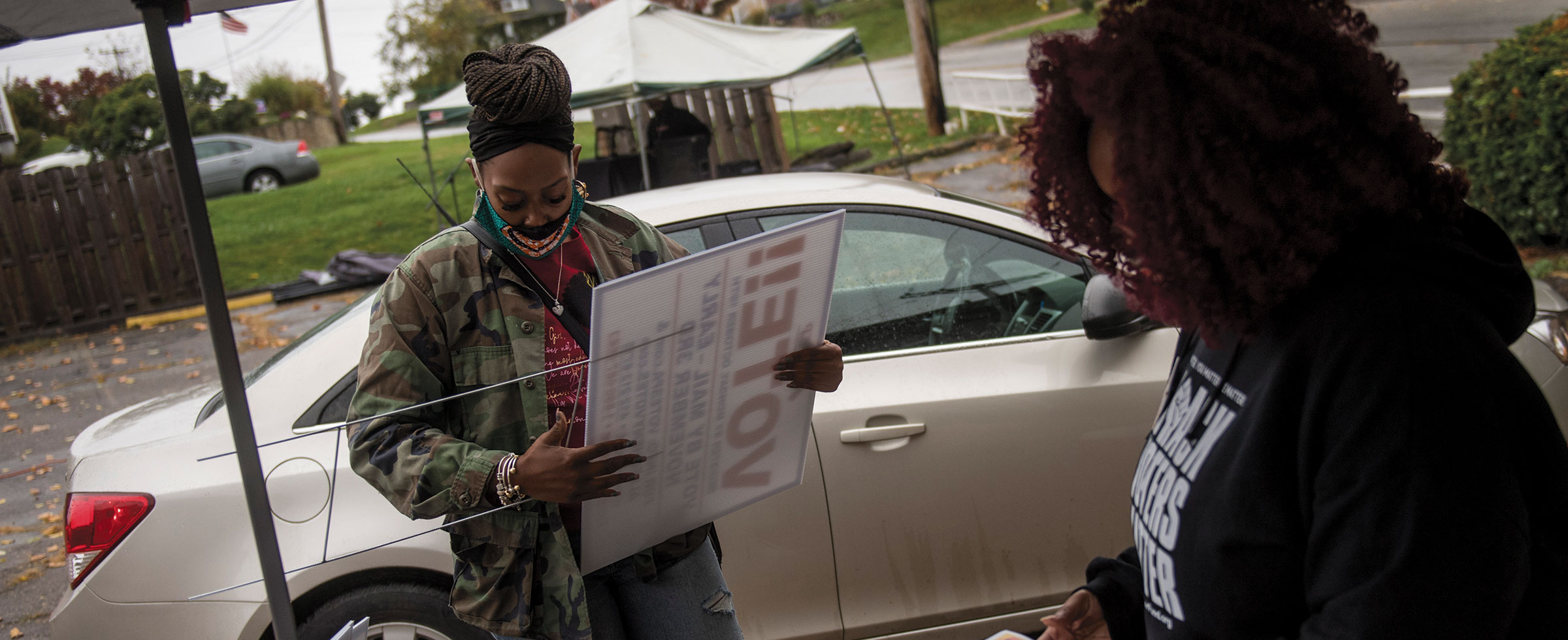 Standing behind the table, Fawn Walker-Montgomery, co-founder and organizing director of Take Action Mon Valley, which combats community violence, encourages people to vote early at an Oct. 24 rally. Photo by Nate Smallwood.