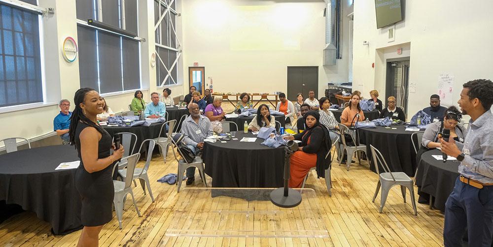 Standing in the foreground, The Pittsburgh Foundation's Senior Program Officer Jamillia Kamara Covington and Program Consultant Chris Ellis lead a discussion at a Small and Mighty information and grant-writing session hosted at the Energy Innovation Center on May 31, 2023.