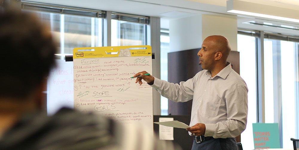 Justin Laing, a consultant from Hillombo, LLC, facilitates a discussion with community advocates and activists. 