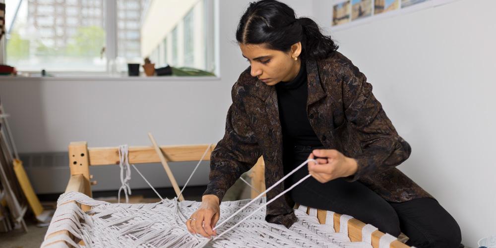 Sobia Ahmed weaving in her studio. Photo by Sean Caroll.