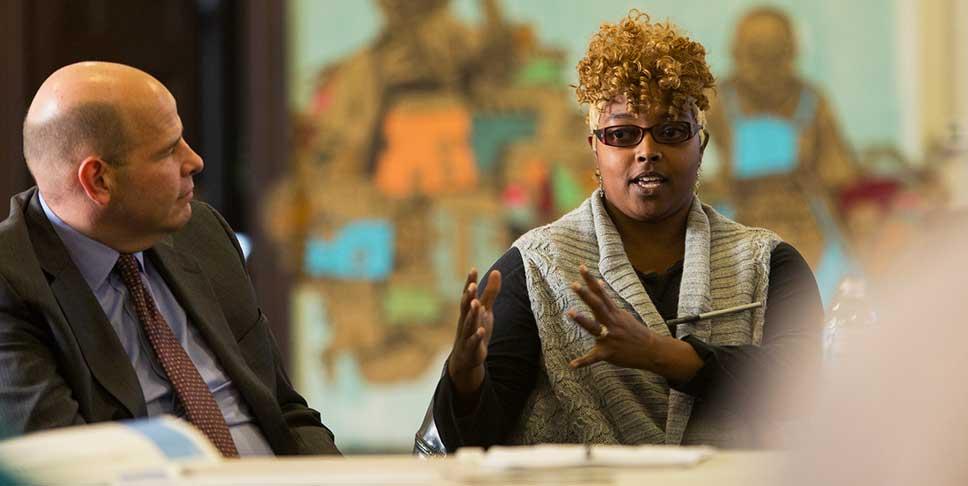 Donor Dwight Mathis (left) listens as Braddock resident Shiane Prunty shares her ideas about programs that are most needed for her community.