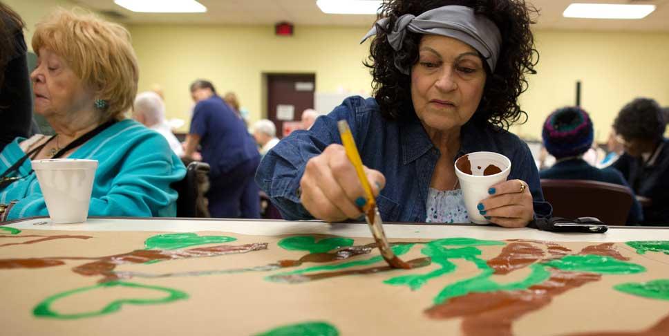 Rose Marie Harris, right, paints leaves on a mural at Community Life of McKeesport through the nonprofit Fine Art Miracles, Inc., which was founded by Tess Lojacono to bring fine art to nursing homes and assisted living facilities. In 2012, Lojacono was awarded $100,000 as part of the Experienced Dreamers contest to raise awareness of the region as a great place to live, work and realize your dreams, regardless of age.