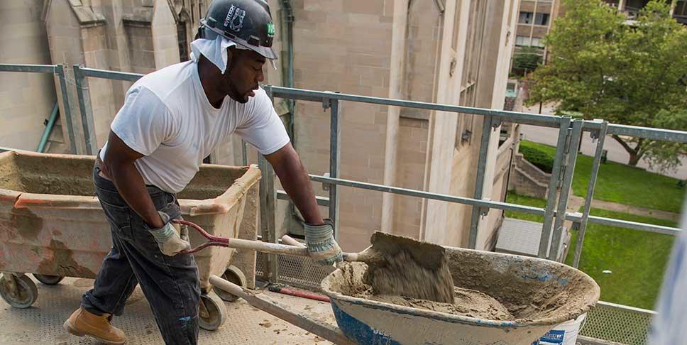 Meaningful employment is a key component of healthy communities. Here, Marcus Kelley, a graduate of the Trade Institute, works at a job site in Oakland.
